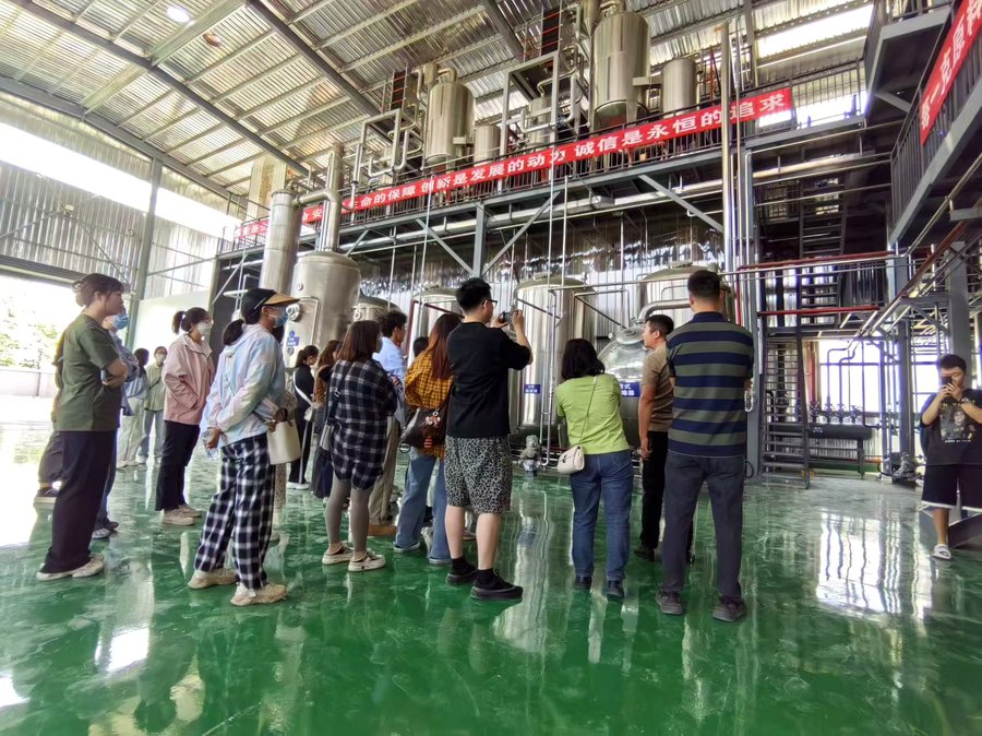 Visitors touring the extraction hall at our partner production facility